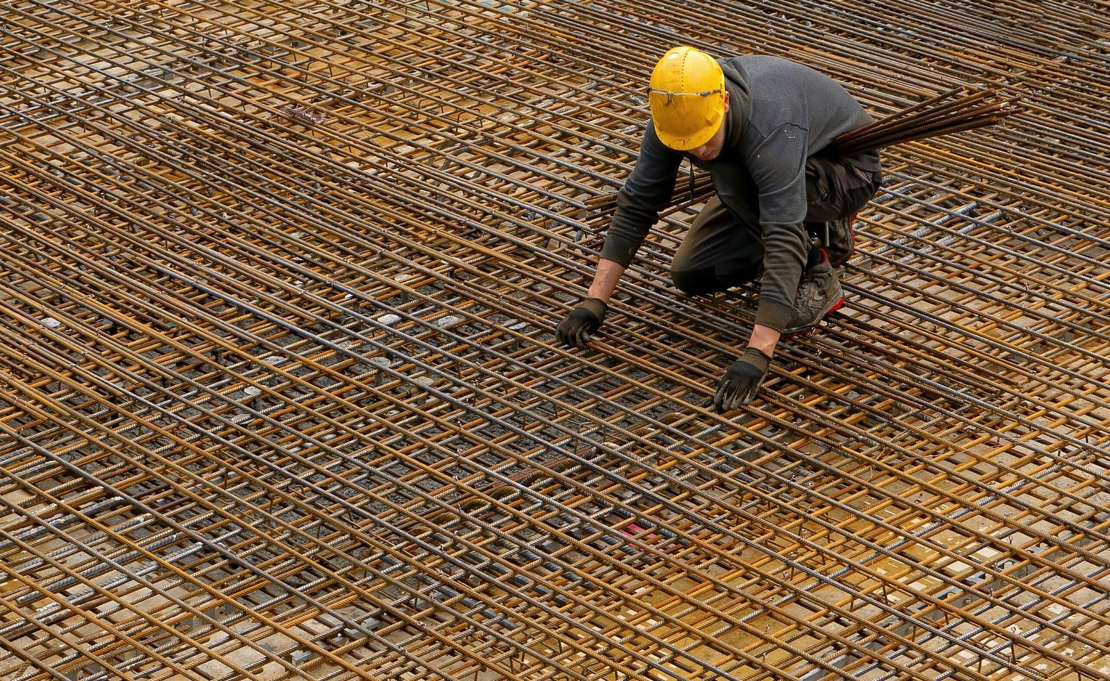 Reinforcement steel rebar placement on a construction site showing concrete cover spacers