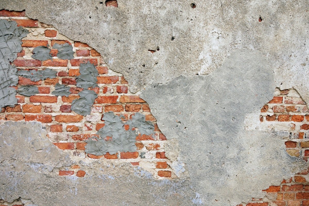 Mason plastering concrete block wall on a construction site