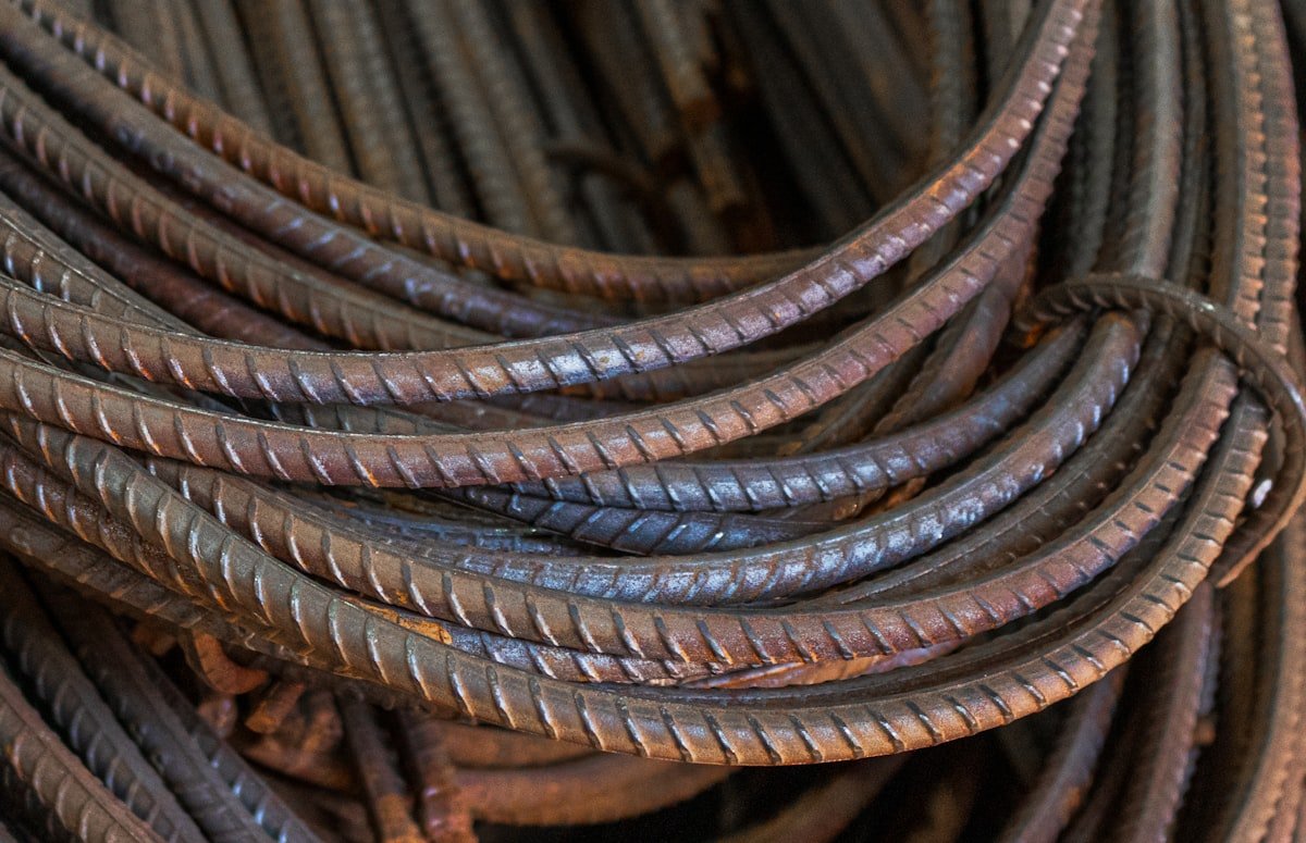 Bundled steel rebar reinforcement bars used in reinforced concrete construction showing the texture of deformed bars