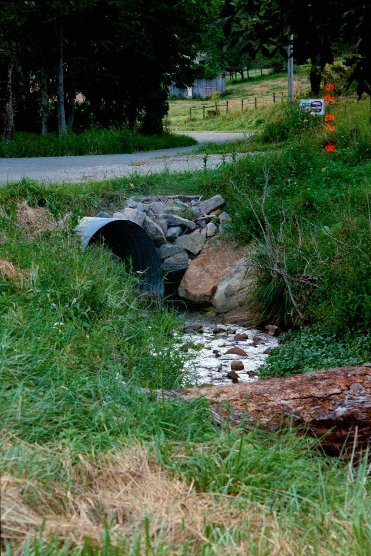 Concrete culvert installed under a road for drainage