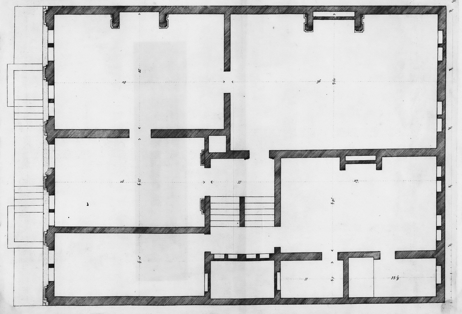 Architectural floor plan drawing on a desk with drafting tools