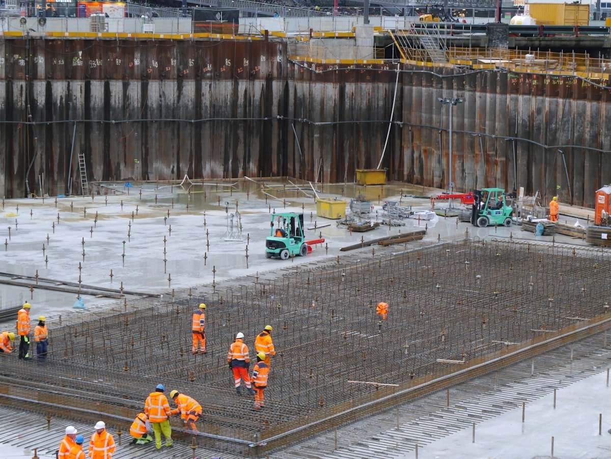 Construction workers setting out and checking a building foundation on a construction site
